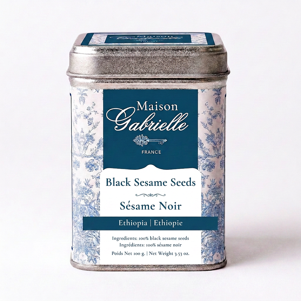 A metal tin of Maison Gabrielle Black Sesame Seeds (Sésame Noir) from Ethiopia, featuring a blue and white floral pattern with a dark blue label.