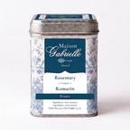 A metal tin of Maison Gabrielle Rosemary from France, featuring a blue and white floral pattern with a dark blue label, set against a plain white background.
