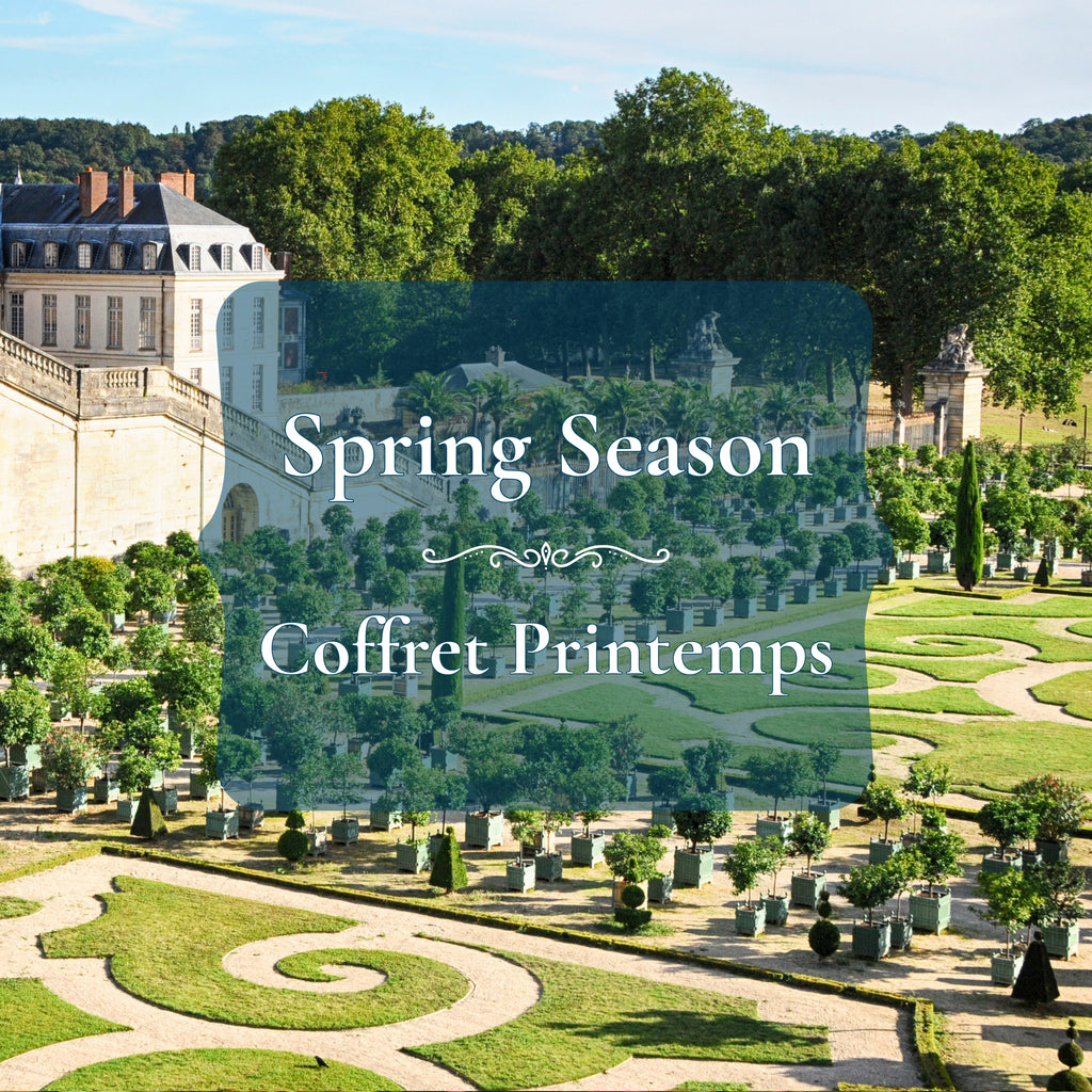 A scenic garden landscape with manicured green lawns, winding stone paths, trees, and a large pale stone building in the background. A semi-transparent dark teal overlay across the center reads 'Spring Season' and 'Coffret Printemps' in white text.