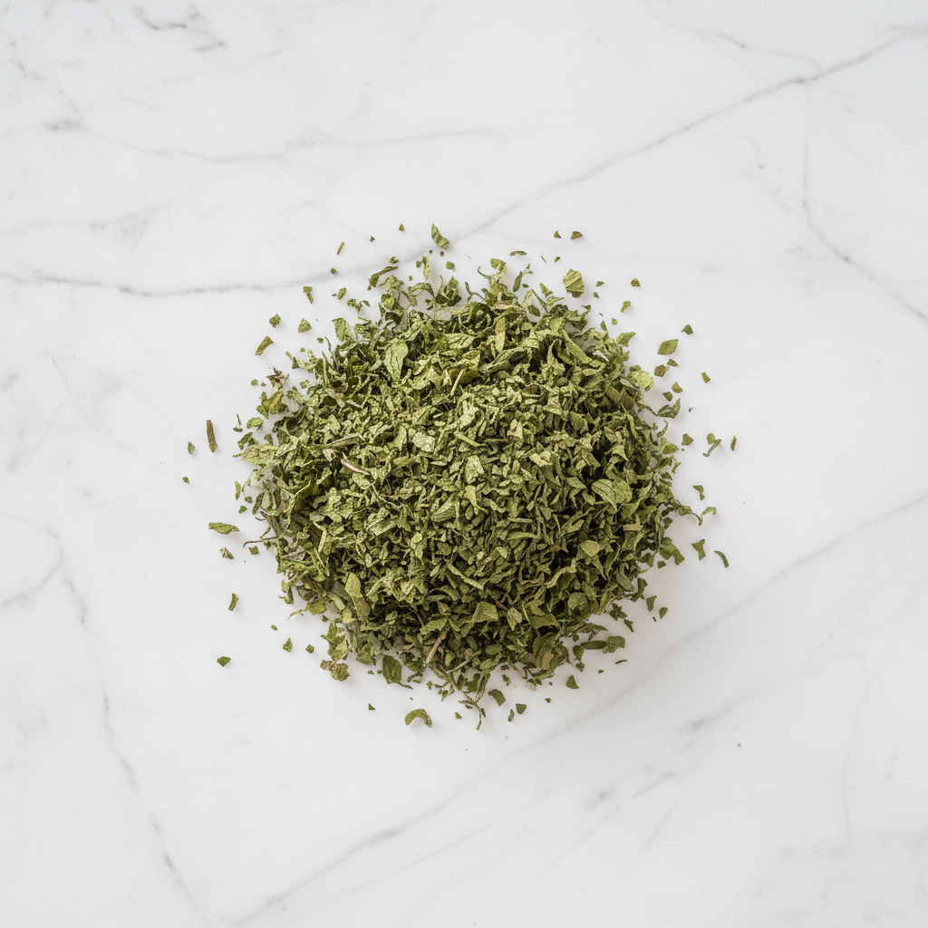 Maison Gabrielle Dried Mint Leaves Piled on a White Marble Surface for Culinary and Tea Use