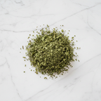 Maison Gabrielle Dried Mint Leaves Piled on a White Marble Surface for Culinary and Tea Use