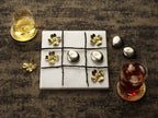 Maison Gabrielle Michael Aram Luxury Dogwood Tic Tac Toe Game and Gold Lemon Coasters Lifestyle Setting