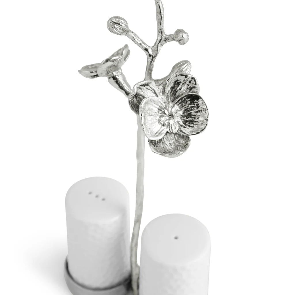 Maison Gabrielle Michael Aram White Orchid Salt and Pepper Shakers Closeup with Textured Silver Orchid Petals and Porcelain Shakers