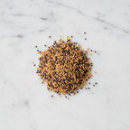 Maison Gabrielle Yellow and Black Mustard Seed Blend Piled on a White Marble Surface for Pickling and Gourmet Recipes