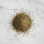 High-Quality Dried Oregano from Maison Gabrielle, Artfully Piled on a White Marble Surface to Showcase Texture and Culinary Freshness