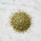 High-Quality Artisanal Herbes de Provence Blend by Maison Gabrielle, Featuring Dried Rosemary, Thyme, Basil, Oregano and Majoram Piled on a White Marble Surface to Showcase Freshness and Texture
